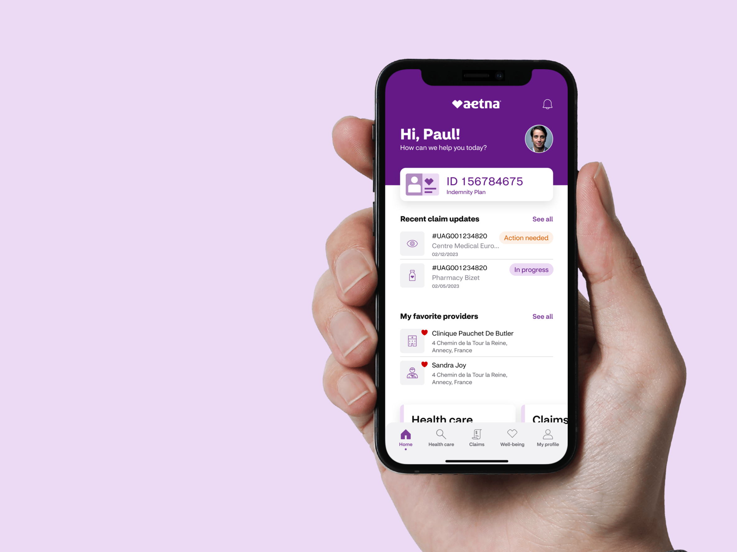 A hand holding a smartphone where you can see the Aetna member website.