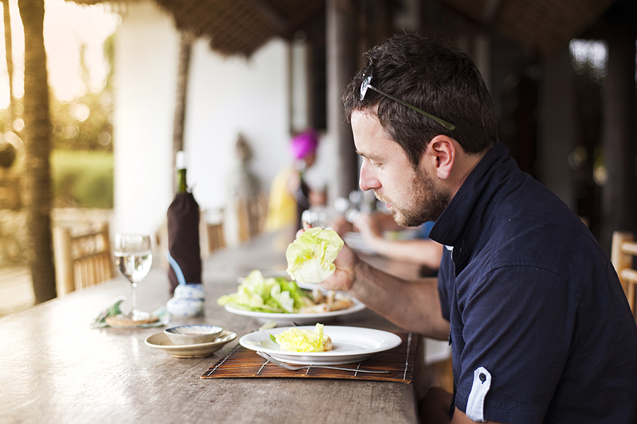 Man eating at table in restaurant