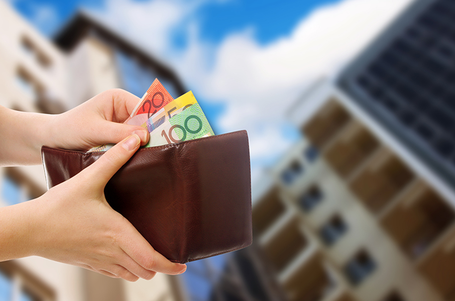 taking out money wallet with skyscraper in background