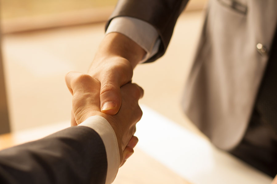 Shaking hands across table