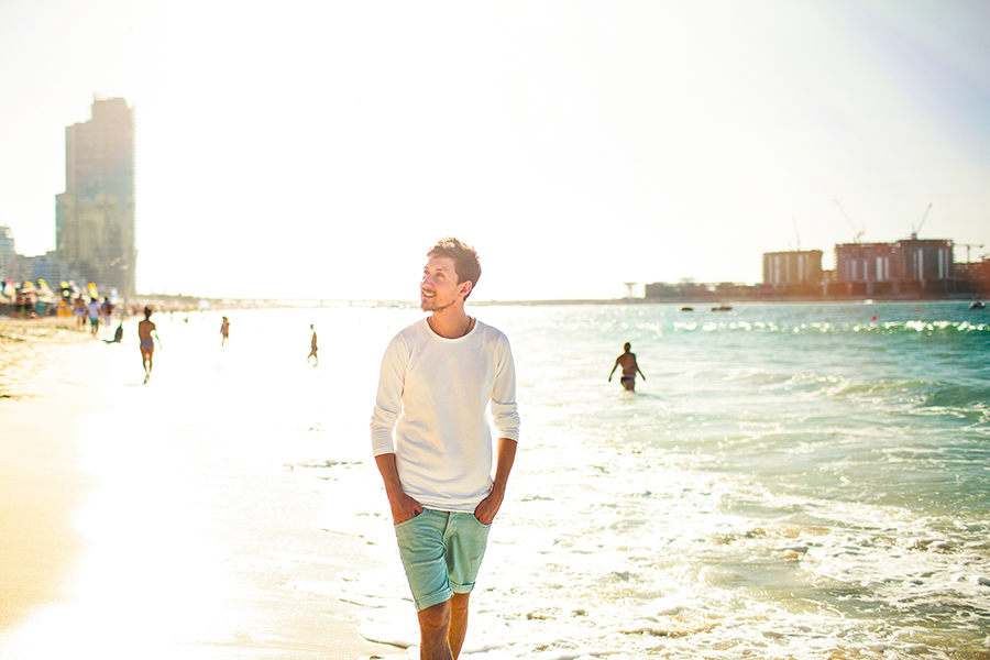 Man strolling on beach in Dubai
