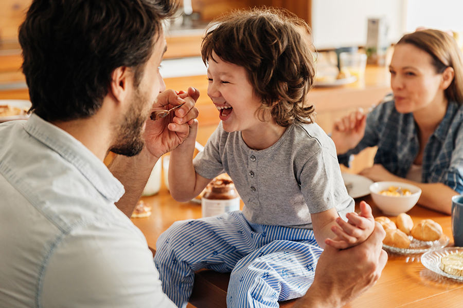 family eating breakfast, smiling
